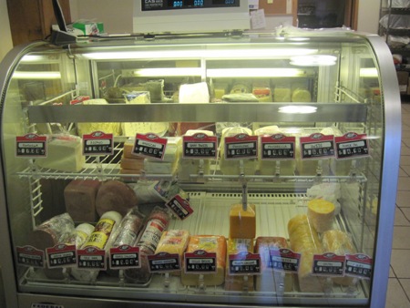 Deli Case with an assortment of meats and cheeses.